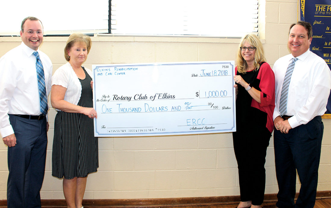 The Inter-Mountain photo by Brooke Binns On behalf of Elkins Rehabilitation and Care Center, Betsy Jones, chief financial officer, second from left, and Tara Shaver, administrator, present the Rotary Club of Elkins with a $1,000 donation for the club’s amphitheater project in the Elkins Town Square. Also pictured are Hoy Ferguson, past Rotary president, left, and Carl Nichols, Rotary president.